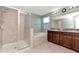 Bathroom showcasing a shower, tub, and dual sink vanity, designed for relaxation and convenience at 16717 Myrtle Sand Dr, Wimauma, FL 33598