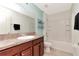 Bathroom with a vanity, a combination tub and shower, and modern fixtures at 16717 Myrtle Sand Dr, Wimauma, FL 33598