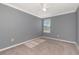 Empty bedroom featuring neutral paint, carpet, and a window at 16717 Myrtle Sand Dr, Wimauma, FL 33598