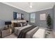 Serene bedroom featuring modern decor and a large window, creating a peaceful and inviting space at 16717 Myrtle Sand Dr, Wimauma, FL 33598
