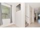 Bright hallway with staircase and window, offering natural light at 16717 Myrtle Sand Dr, Wimauma, FL 33598