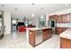 Open concept kitchen with stainless steel appliances, tile floors and center island at 16717 Myrtle Sand Dr, Wimauma, FL 33598