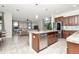 Open concept kitchen with stainless steel appliances, tile floors and center island at 16717 Myrtle Sand Dr, Wimauma, FL 33598