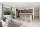Open kitchen and dining area with marble countertops and stainless steel appliances at 16717 Myrtle Sand Dr, Wimauma, FL 33598