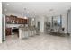 Modern kitchen with stainless steel appliances and center island with bar stool seating at 16717 Myrtle Sand Dr, Wimauma, FL 33598