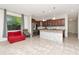 Open kitchen and dining area with marble countertops and stainless steel appliances at 16717 Myrtle Sand Dr, Wimauma, FL 33598