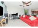 Spacious living room with ceiling fan, tile floors and large TV at 16717 Myrtle Sand Dr, Wimauma, FL 33598
