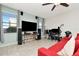 Spacious living room with ceiling fan, tile floors and large TV at 16717 Myrtle Sand Dr, Wimauma, FL 33598