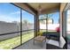 Screened patio featuring a table and chair with views of the yard at 16717 Myrtle Sand Dr, Wimauma, FL 33598