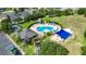 Aerial view of community pool, clubhouse, playground, tennis court, and parking lot in a desirable neighborhood at 1806 Mira Lago Cir, Ruskin, FL 33570