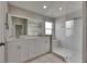 Modern bathroom featuring a double vanity with white cabinets and a glass-enclosed shower at 1806 Mira Lago Cir, Ruskin, FL 33570