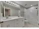 Bright bathroom boasts a double vanity and bathtub with white tile surround at 1806 Mira Lago Cir, Ruskin, FL 33570