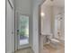 A well-lit bathroom adjacent to a doorway to the exterior at 1806 Mira Lago Cir, Ruskin, FL 33570