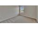 Empty bedroom features a window and neutral carpet at 1806 Mira Lago Cir, Ruskin, FL 33570