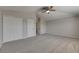 Bright bedroom with gray carpet, ceiling fan, and white closets and doors offers a clean and modern aesthetic at 1806 Mira Lago Cir, Ruskin, FL 33570