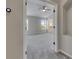 View from doorway of a bedroom featuring a ceiling fan, walk-in closet, and neutral colored walls at 1806 Mira Lago Cir, Ruskin, FL 33570