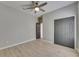 Light-filled bedroom features a ceiling fan, wood-look floors, and gray walls at 1806 Mira Lago Cir, Ruskin, FL 33570