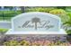 Elegant stone and stucco sign for Mira Lago community near a scenic pond and lush landscaping at 1806 Mira Lago Cir, Ruskin, FL 33570