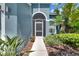 Up close shot of the front door with nice landscaping and a walkway at 1806 Mira Lago Cir, Ruskin, FL 33570