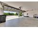 Spacious garage interior with high ceilings and an open overhead door with outside views at 1806 Mira Lago Cir, Ruskin, FL 33570