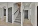 The foyer features hardwood flooring, a gray staircase, and gray doors at 1806 Mira Lago Cir, Ruskin, FL 33570