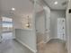 Light-filled hallway featuring neutral paint, carpet, and an ornate chandelier on the second floor at 1806 Mira Lago Cir, Ruskin, FL 33570