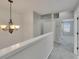 Carpeted hallway featuring neutral paint, chandelier, and access to other rooms at 1806 Mira Lago Cir, Ruskin, FL 33570