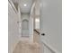 Bright hallway features storage closets, a unique archway, and neutral colors, offering style and functionality at 1806 Mira Lago Cir, Ruskin, FL 33570