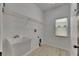 Laundry room with a utility sink, upper wire rack, and window for natural light at 1806 Mira Lago Cir, Ruskin, FL 33570