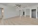 Open-concept living room featuring a ceiling fan and decorative archways at 1806 Mira Lago Cir, Ruskin, FL 33570