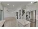 Bright living room area featuring hardwood floors, stainless steel appliances, and a staircase at 1806 Mira Lago Cir, Ruskin, FL 33570