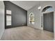 Open-concept living room with high ceilings, new light wood floors, and abundant natural light at 1806 Mira Lago Cir, Ruskin, FL 33570