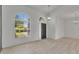 Bright and airy living room featuring wood floors, a front door and large windows at 1806 Mira Lago Cir, Ruskin, FL 33570