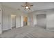 Bright main bedroom featuring walk-in closet, neutral paint, carpet, and ceiling fan at 1806 Mira Lago Cir, Ruskin, FL 33570