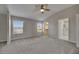 Spacious main bedroom with large windows, a ceiling fan, and ensuite bath and walk-in closet at 1806 Mira Lago Cir, Ruskin, FL 33570