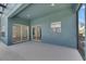 Covered patio with textured floor, offers an inviting transition between indoor/outdoor living spaces at 1806 Mira Lago Cir, Ruskin, FL 33570