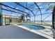 Gorgeous in-ground pool with screened enclosure and picturesque lake views, creating a relaxing outdoor oasis at 1806 Mira Lago Cir, Ruskin, FL 33570