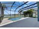 Beautiful in-ground pool with screened enclosure, offers stunning lake views and outdoor entertainment space at 1806 Mira Lago Cir, Ruskin, FL 33570