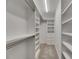 Organized walk-in closet with shelving and hanging rods, maximizing storage space at 1806 Mira Lago Cir, Ruskin, FL 33570
