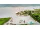 An aerial view of beach-front property with private beach access and a sandy courtyard for outdoor entertaining at 18102 2Nd St E, Redington Shores, FL 33708