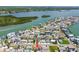 Aerial view of a neighborhood with a body of water nearby at 18102 2Nd St E, Redington Shores, FL 33708