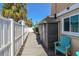 Exterior side of the house featuring a wooden deck and outdoor storage at 18102 2Nd St E, Redington Shores, FL 33708