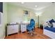 Comfortable bedroom with a desk, chair, and hardwood floors at 18102 2Nd St E, Redington Shores, FL 33708