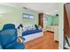 Bedroom showcasing nautical decor, a trundle bed, and hardwood floors at 18102 2Nd St E, Redington Shores, FL 33708