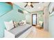 Charming bedroom with a trundle bed, coastal decor, and tile flooring at 18102 2Nd St E, Redington Shores, FL 33708
