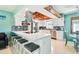 Stylish kitchen with white cabinetry, stainless steel appliances, and breakfast bar seating at 18102 2Nd St E, Redington Shores, FL 33708