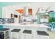 Well-appointed kitchen featuring a breakfast bar, stainless steel appliances, and modern finishes at 18102 2Nd St E, Redington Shores, FL 33708