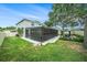View of the home's backyard featuring a screened-in porch, a gazebo with a paver patio and mature landscaping at 1830 Citrus Orchard Way, Valrico, FL 33594