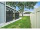 Manicured lawn and screened in back patio on a sunny day at 1830 Citrus Orchard Way, Valrico, FL 33594