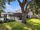 Extensive yard featuring a gazebo, screened in patio, mature trees, and lush lawn at 1830 Citrus Orchard Way, Valrico, FL 33594